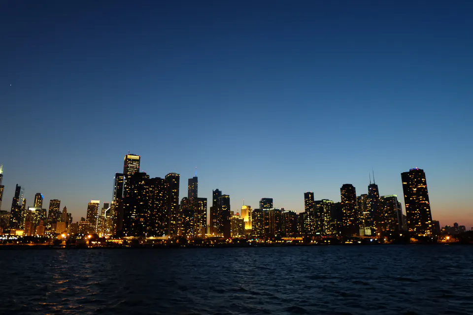 The Chicago skyline at dusk reflected in the lake.